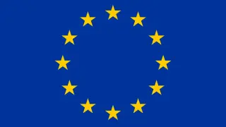 Flaga Unii Europejskiej, symbol jedności i pluralizmu, z dwunastoma złotymi gwiazdami na niebieskim tle.