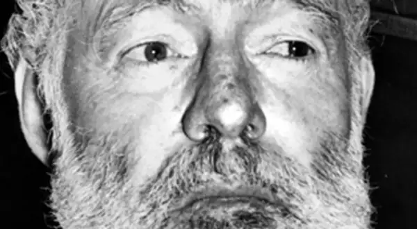 Zbliżenie na twarz Ernesta Hemingwaya z siwą brodą i zmarszczkami. Ciekawe fakty o pisarzu.