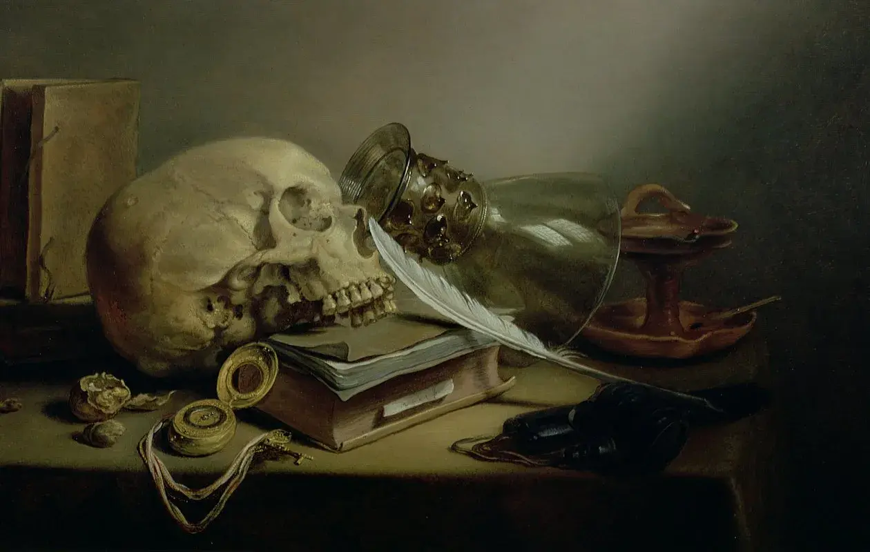 Czaszka, pióro, księga i zegarek – klasyczne symbole vanitas, przypominające o przemijaniu.
