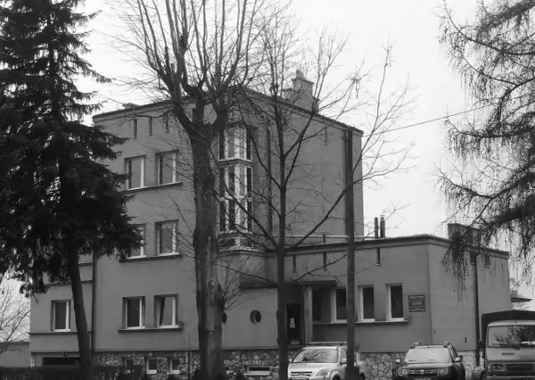 Szare budynki, jak szklane domy przedwiośnie, otoczone nagimi drzewami.